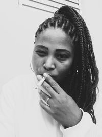 Portrait of young woman smoking cigarette