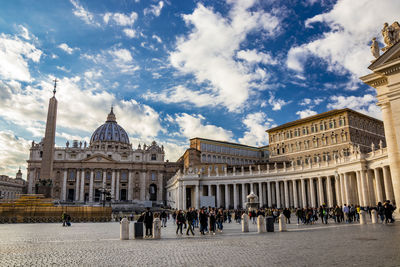 Group of people in front of historic building against sky