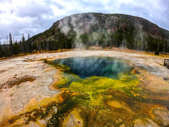 Scenic view of waterfall against sky