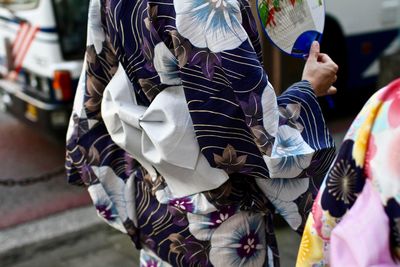 Midsection of japanese women on footpath