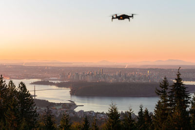 Scenic view of city against sky during sunset