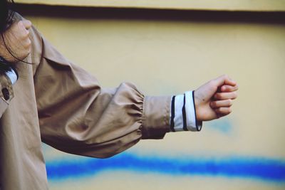 Midsection of woman punching outdoors