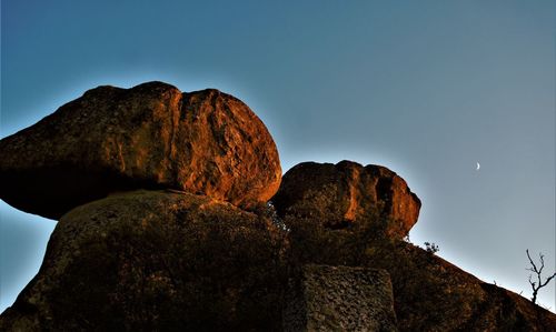 Low angle view of rock formation against sky