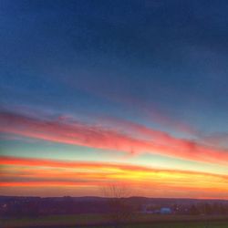 Scenic view of landscape against sky at sunset