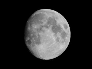 Low angle view of moon against dark sky