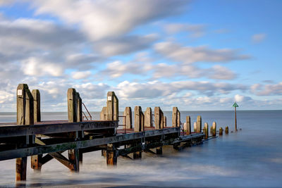 Pier over sea against sky