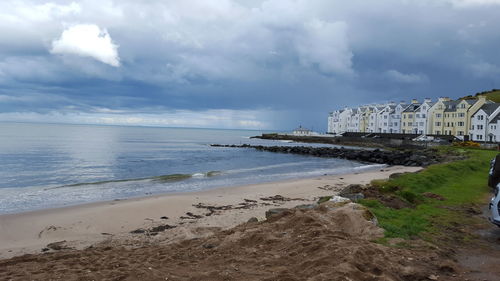 View of beach against cloudy sky