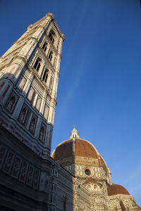 Low angle view of historical building against blue sky