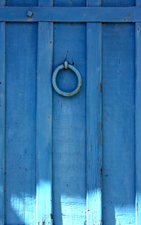 Low angle view of door knocker on blue door