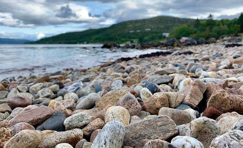 Rocks on beach against sky