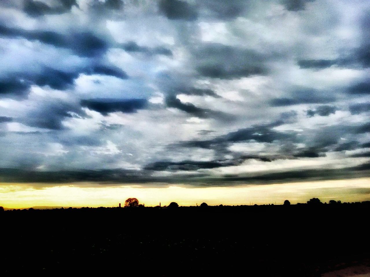 sunset, tranquil scene, sky, silhouette, scenics, landscape, tranquility, beauty in nature, cloud - sky, nature, field, idyllic, cloud, horizon over land, cloudy, dramatic sky, orange color, moody sky, outdoors, rural scene