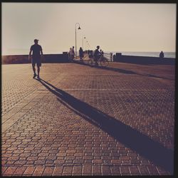 Woman walking on footpath