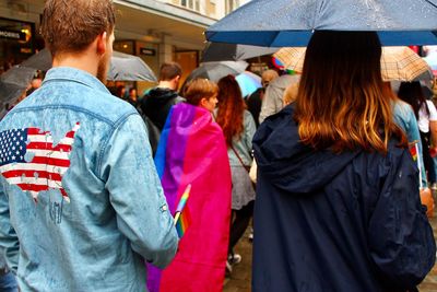 Rear view of people standing in market