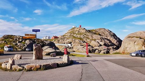 Lindesnes lighthouse on rock formation against sky