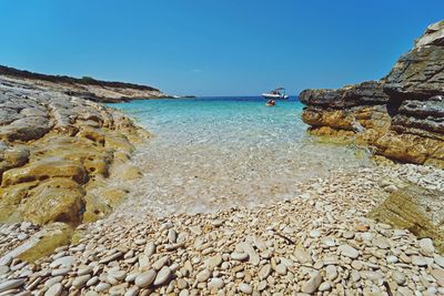 Scenic view of sea against clear blue sky