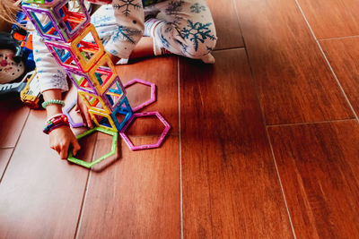 Low section of girl playing with toy at home