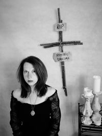 Young woman standing against wall