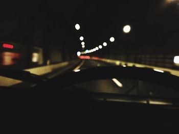 Defocused image of car on road at night