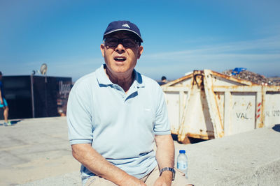 Young man wearing sunglasses standing on sunny day