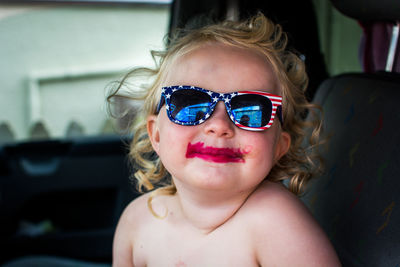 Portrait of shirtless boy wearing sunglasses