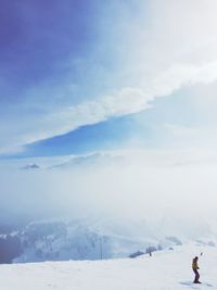 Scenic view of snow covered mountains against sky