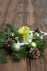 Close-up of lit candle on wreath