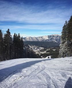 Snow covered landscape against sky