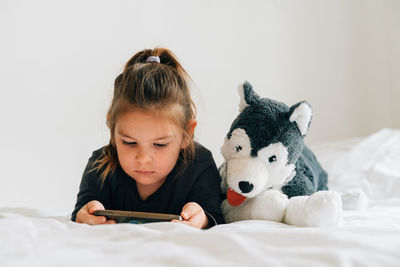 High angle view of girl with dog against white background