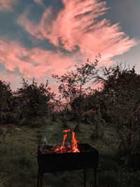 Bonfire against sky at sunset