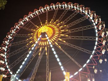 Low angle view of ferris wheel against sky at night