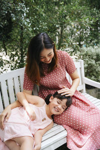 Happy young woman sitting outdoors