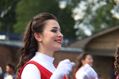 Portrait of smiling young woman looking away outdoors