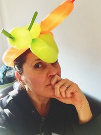 Portrait of woman wearing balloons at home