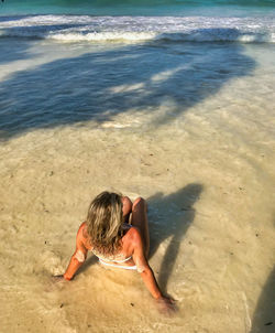 High angle view of woman relaxing on beach