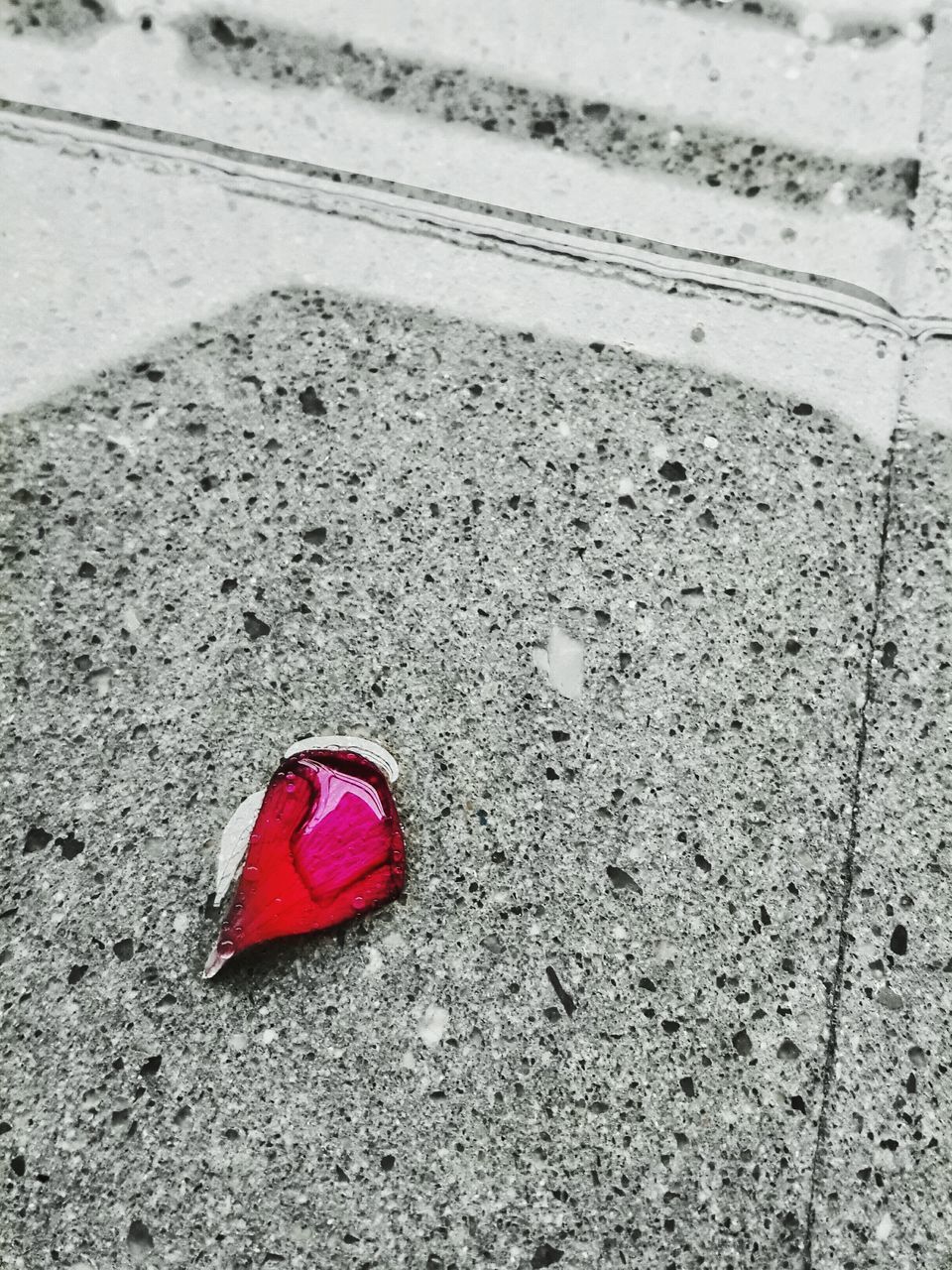 red, high angle view, street, asphalt, textured, close-up, road, day, no people, ground, white color, outdoors, heart shape, pattern, sidewalk, pink color, single object, road marking, identity, sunlight