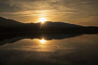 Scenic view of lake against sky during sunset