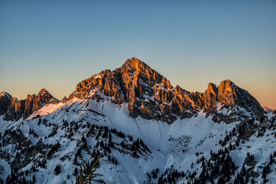 Scenic view of snowcapped mountains against clear sky