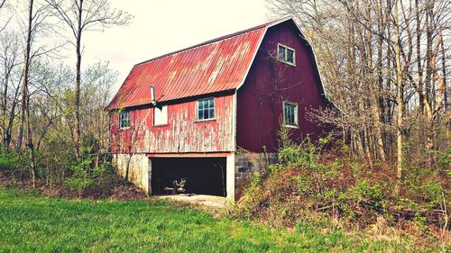 Abandoned house on field against sky