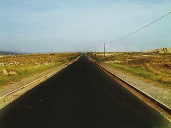 Road amidst landscape against sky