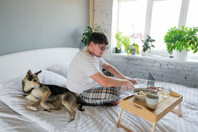 Portrait of woman with dog at home