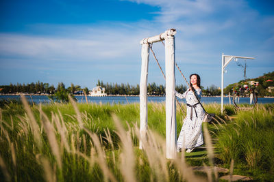 Woman standing on field against sky