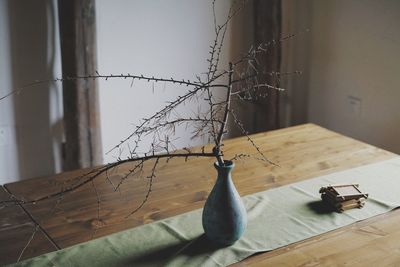 Close-up of window on table against wall at home