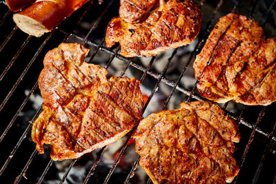 High angle view of meat on barbecue grill