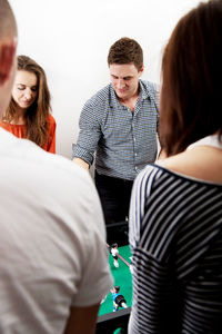 Friends playing foosball