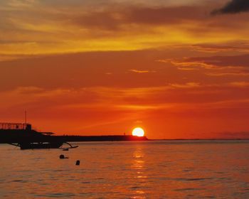 Scenic view of sea against romantic sky at sunset