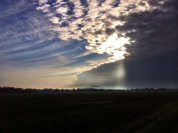 Scenic view of landscape against cloudy sky