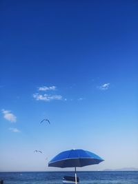 Scenic view of sea against blue sky