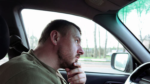 Close-up of man sitting in car