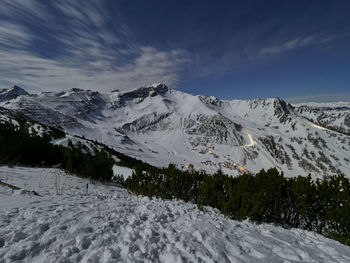 Scenic view of snow covered mountains against sky