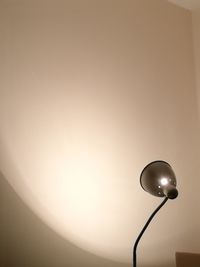 Low angle view of illuminated lamp against sky